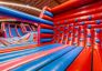 Climb Wall obstacle in inflatable park – red and blue inflatable climbing wall with hand and foot grips