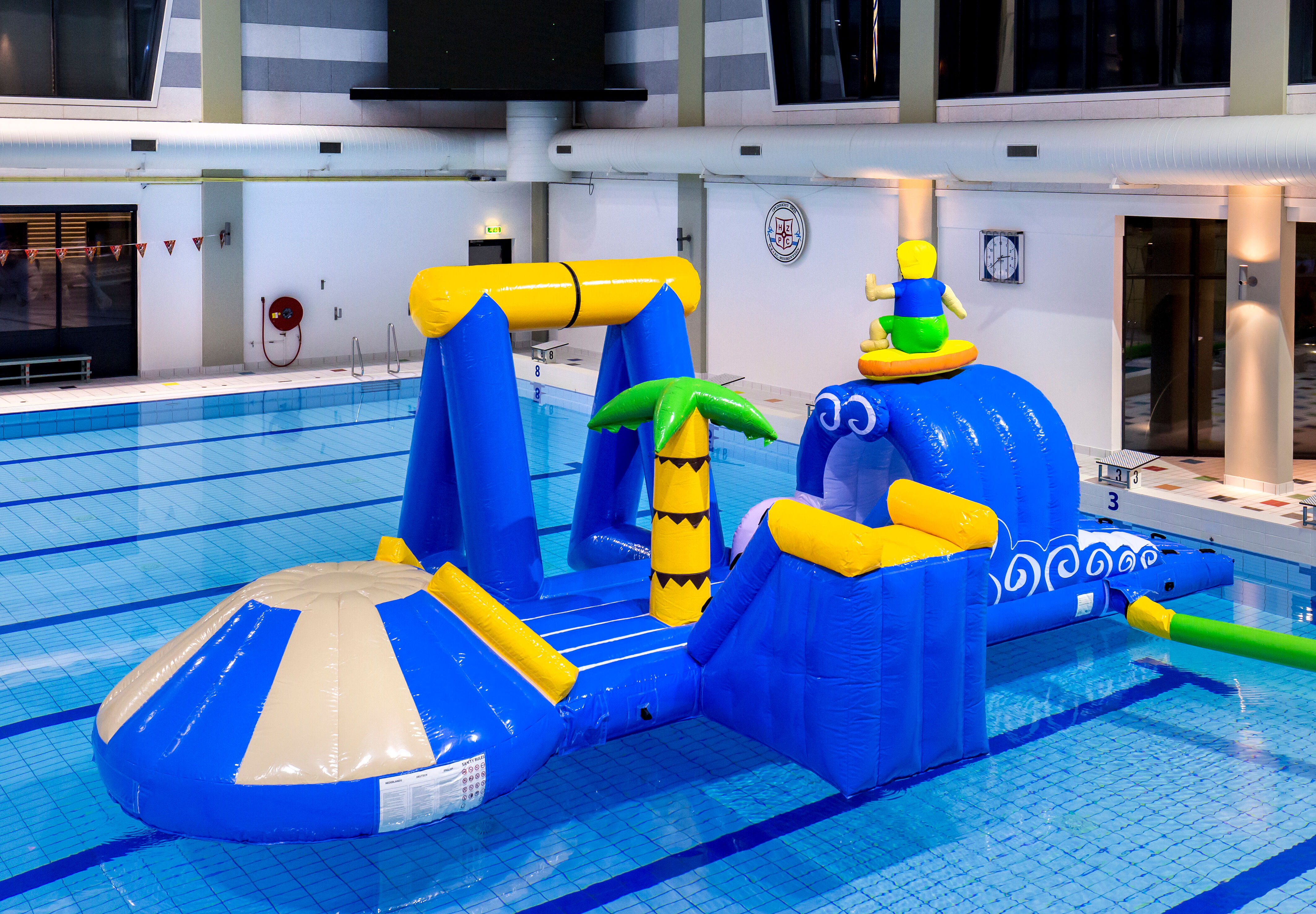 Unique airtight inflatable surfer play island with a vine, climbing tower, round slide and obstacles for both young and old. Buy inflatable pool games now online at JB Inflatables America